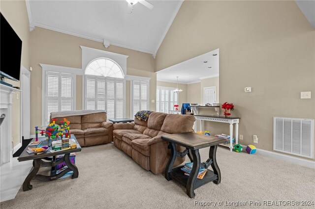 living room featuring light carpet, ceiling fan with notable chandelier, high vaulted ceiling, and crown molding