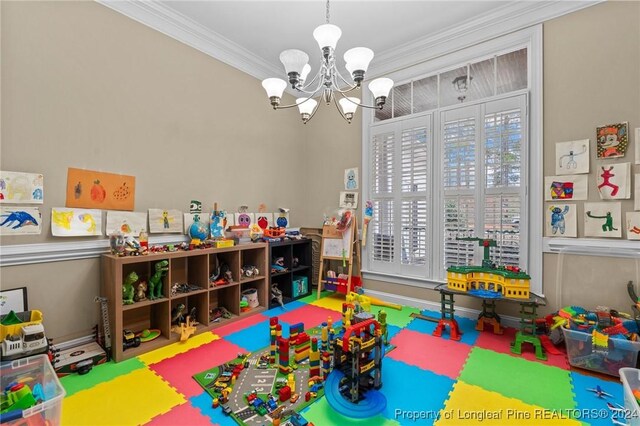 game room featuring an inviting chandelier and crown molding