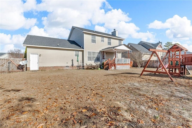 back of house with a playground