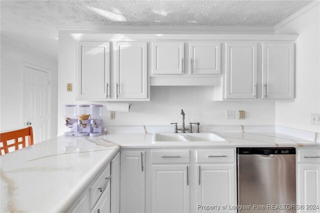 kitchen with sink, stainless steel dishwasher, a textured ceiling, white cabinets, and ornamental molding