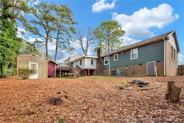 back of house with central AC and a deck