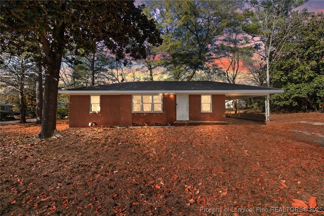 single story home featuring a carport