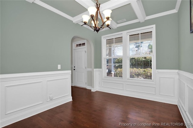 unfurnished room with beamed ceiling, dark hardwood / wood-style floors, ornamental molding, and a chandelier