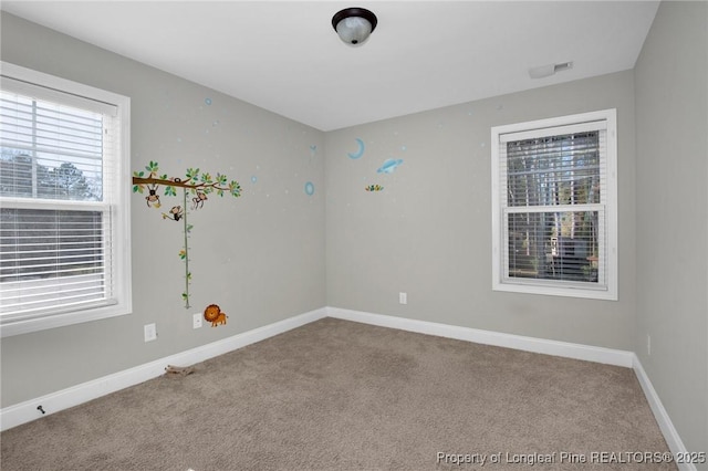 spare room with light colored carpet