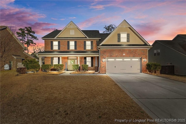 view of front of house featuring a garage and a lawn