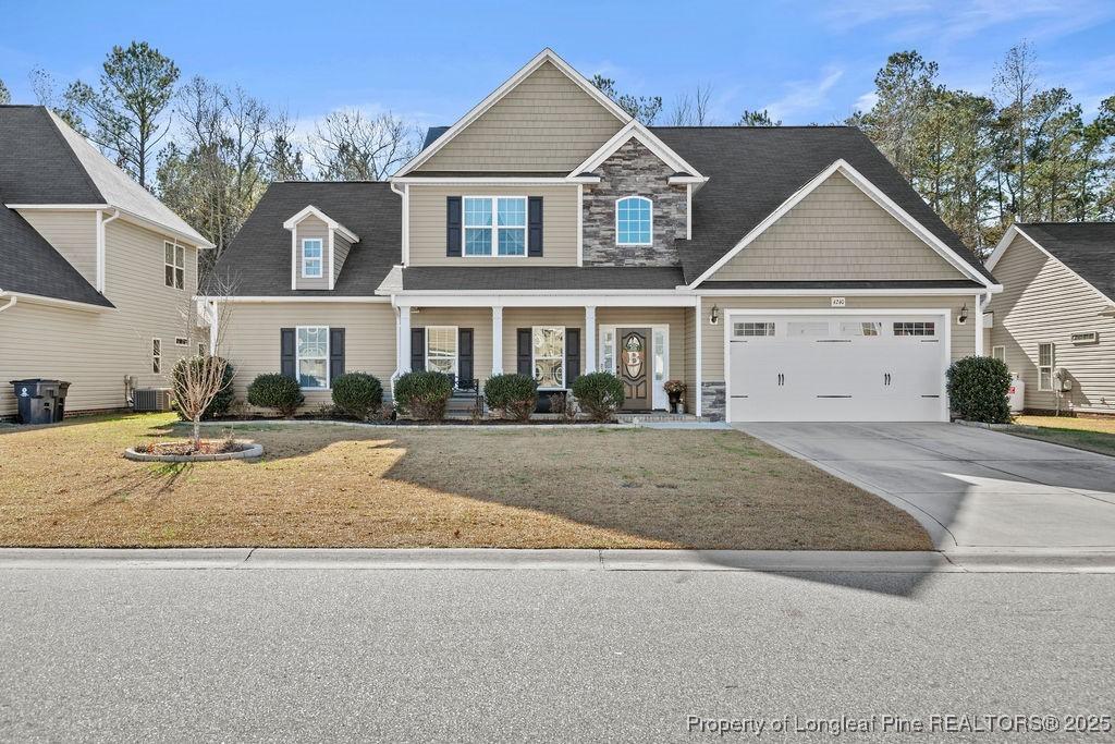 view of front of property featuring a front lawn and central air condition unit