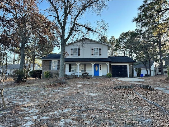 view of front of property featuring a porch and a garage