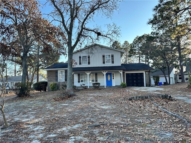 view of front facade featuring covered porch and a garage