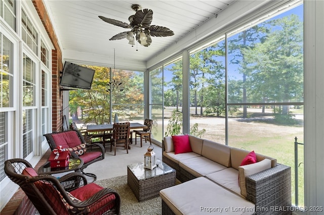 sunroom featuring a wealth of natural light and ceiling fan