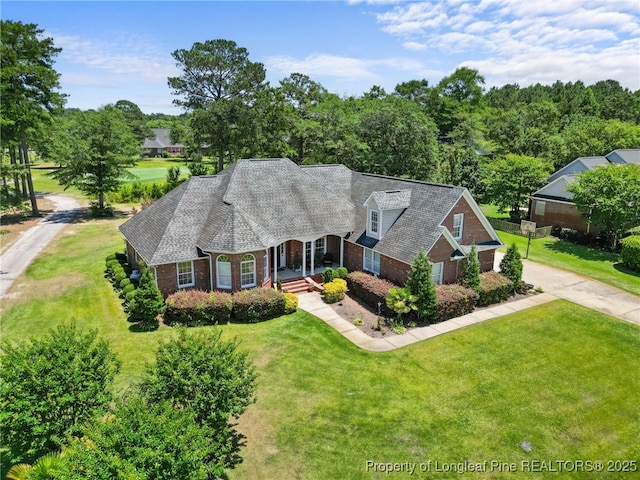 cape cod home with a front yard