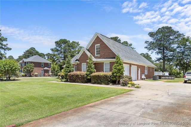 view of front of house with a garage and a front lawn