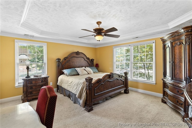 carpeted bedroom featuring crown molding, a tray ceiling, a textured ceiling, and ceiling fan