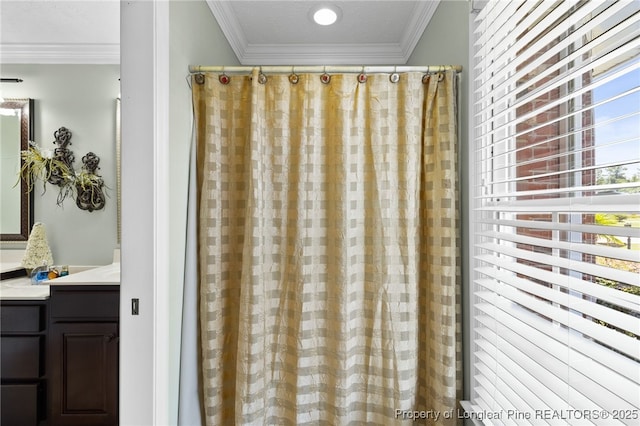 bathroom featuring crown molding and a healthy amount of sunlight