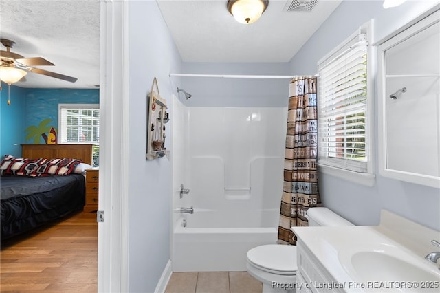 full bathroom with toilet, a textured ceiling, vanity, shower / bathtub combination with curtain, and ceiling fan