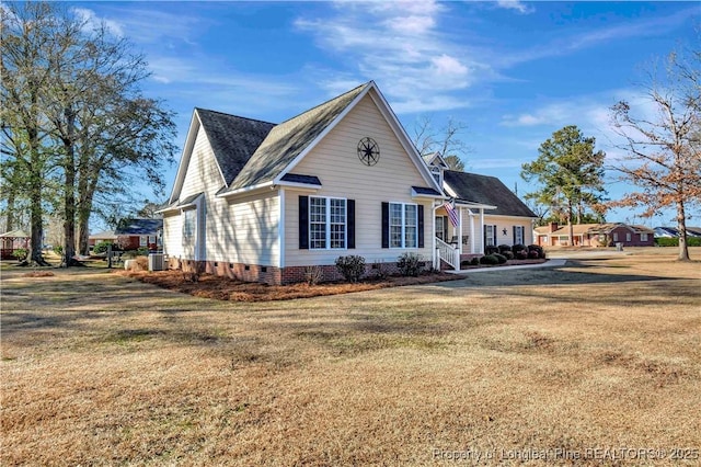 view of front of house with central AC unit and a front yard