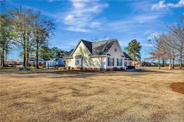 view of home's exterior with a yard