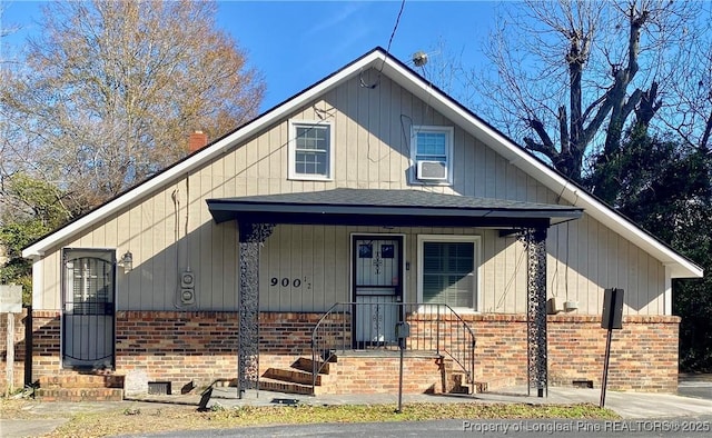 view of front of home with cooling unit and covered porch