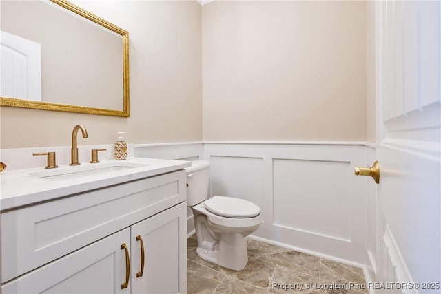 bathroom featuring vanity and toilet