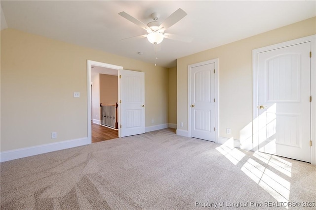 unfurnished bedroom with light colored carpet and ceiling fan