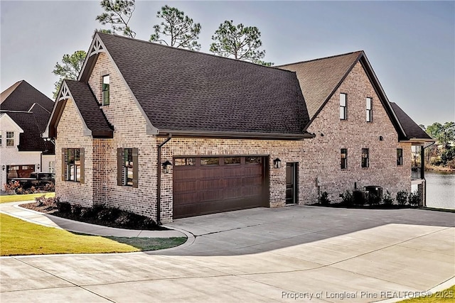 view of front of home with a garage and central AC unit