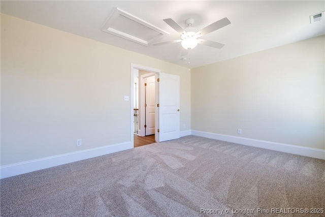 carpeted spare room featuring ceiling fan