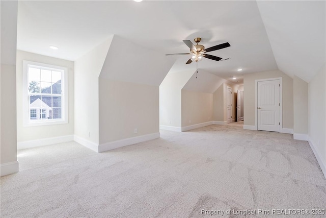 bonus room featuring ceiling fan, lofted ceiling, and light carpet