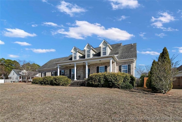 new england style home with a front yard