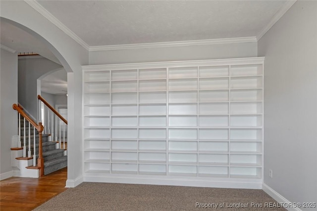 interior space featuring built in features and ornamental molding