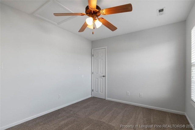 carpeted spare room featuring ceiling fan and plenty of natural light