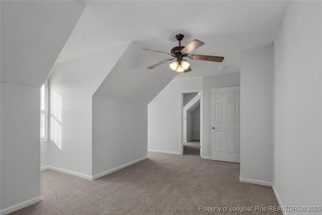 additional living space with ceiling fan, light colored carpet, and lofted ceiling