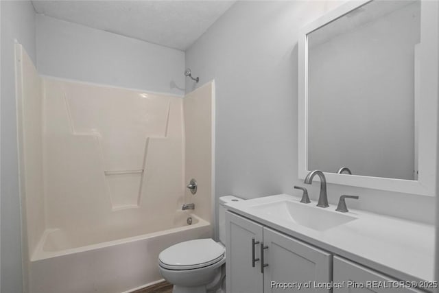 full bathroom with vanity, toilet, bathing tub / shower combination, and a textured ceiling