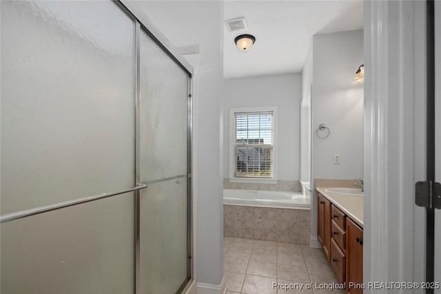 bathroom featuring vanity, shower with separate bathtub, and tile patterned floors