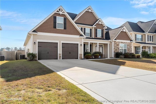 craftsman-style house with a garage, a front yard, and central AC unit