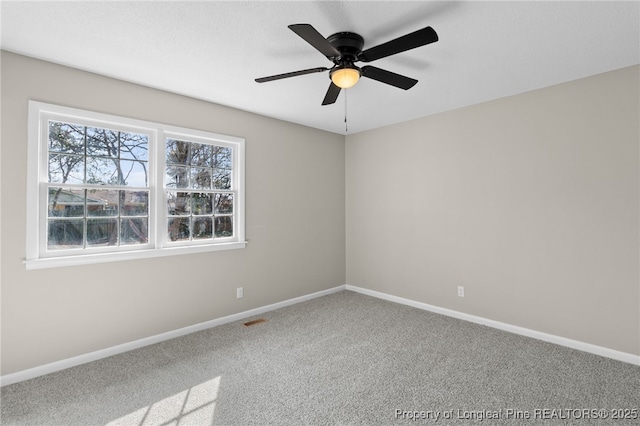 empty room with ceiling fan and carpet flooring