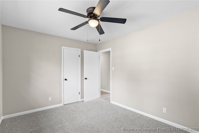 unfurnished bedroom featuring light colored carpet and ceiling fan