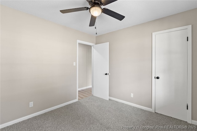 unfurnished bedroom with light colored carpet and ceiling fan