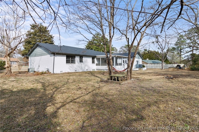 back of property featuring a lawn