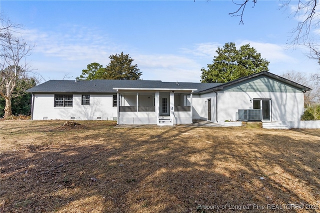 back of property with central AC unit, a yard, and a sunroom