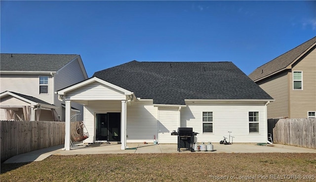 rear view of house with a yard and a patio area