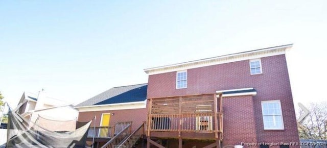 back of house featuring a wooden deck