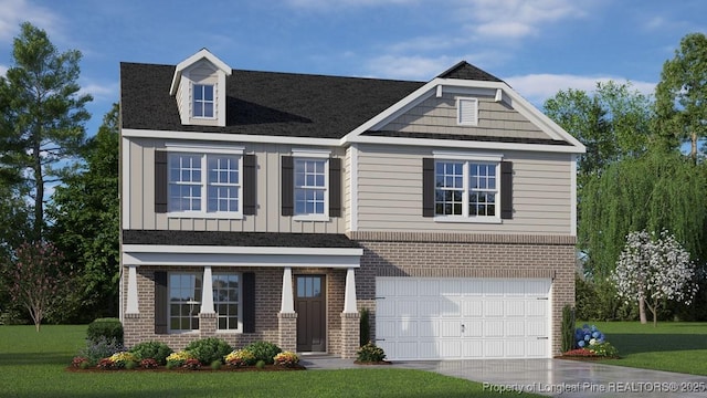 craftsman-style house featuring a front yard and a garage