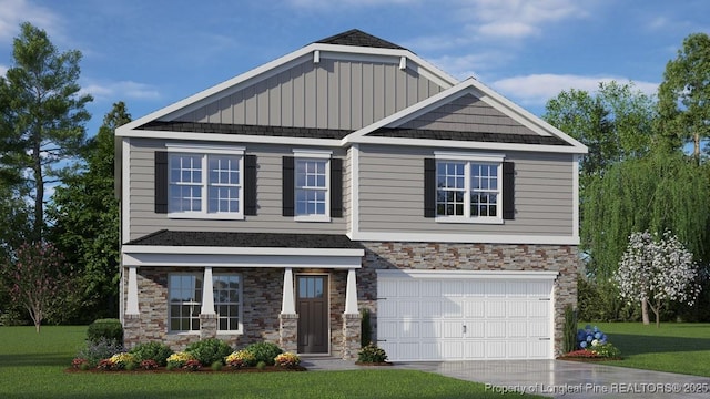 craftsman house with a garage and a front lawn