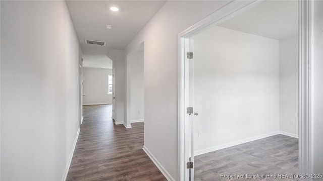 hallway featuring dark hardwood / wood-style floors