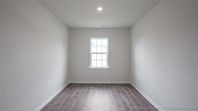 empty room with hardwood / wood-style flooring