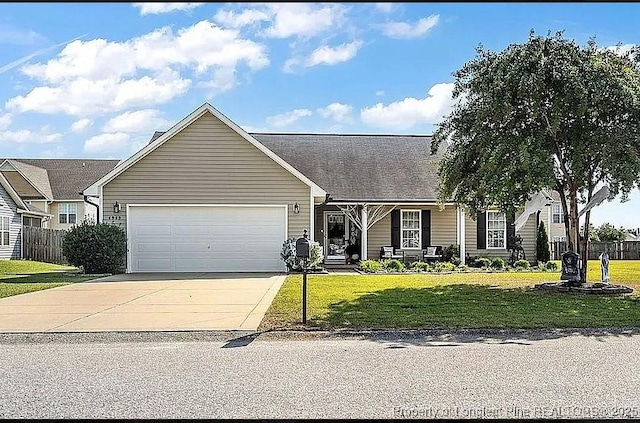 view of front of house with a garage, concrete driveway, a front yard, and fence