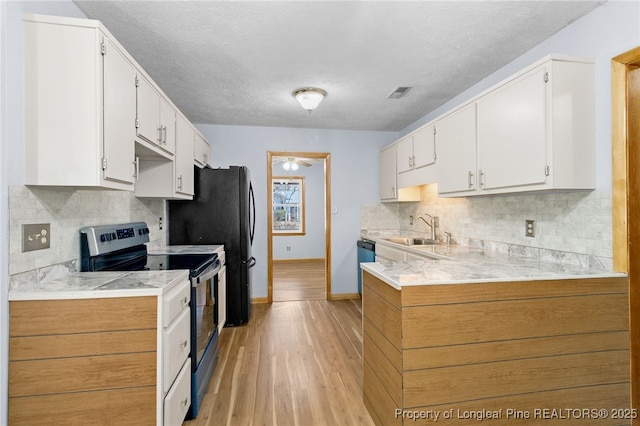 kitchen with appliances with stainless steel finishes, light countertops, and white cabinets