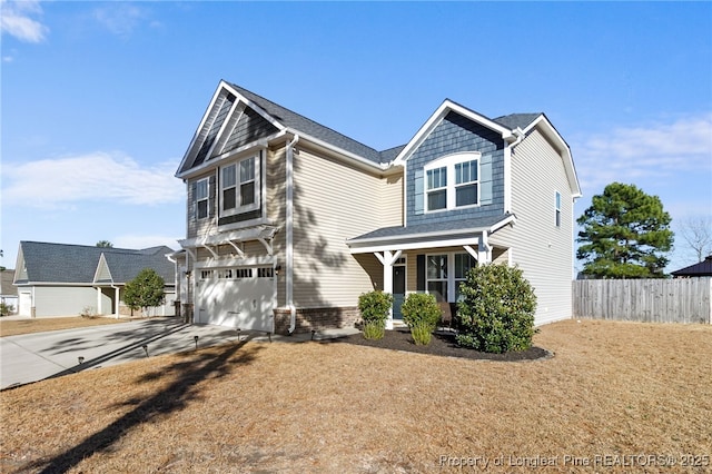 craftsman house with an attached garage, fence, a porch, and concrete driveway