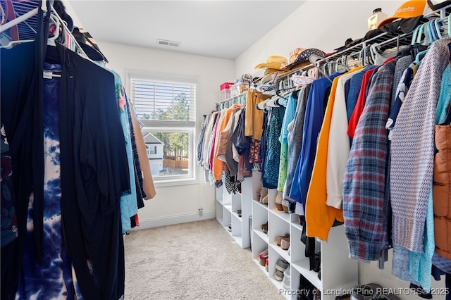 spacious closet with carpet flooring and visible vents