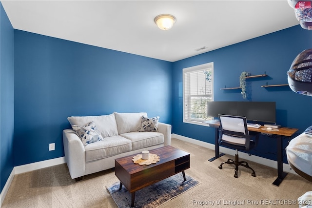 carpeted home office with baseboards and visible vents