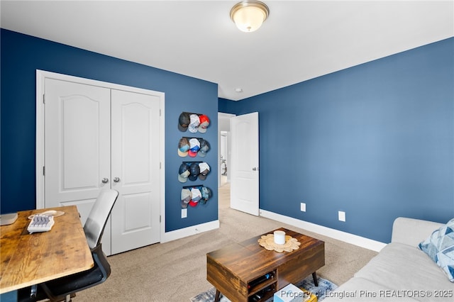 living area featuring light colored carpet and baseboards